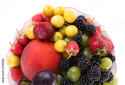 Different berries and fruits in plate isolated on white © Africa Studio
