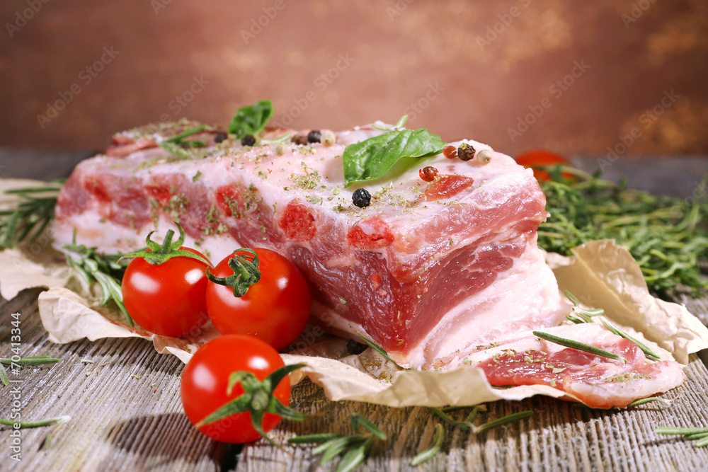 raw bacon with spices and tomatoes on wooden table