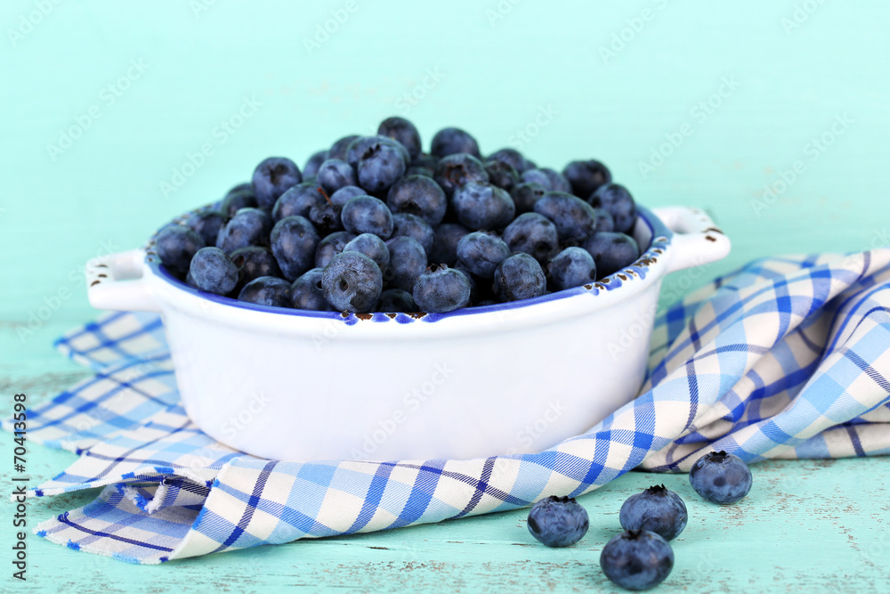 Tasty ripe blueberries in bowl, on wooden table Tasty ripe blueberries in bowl, on wooden table