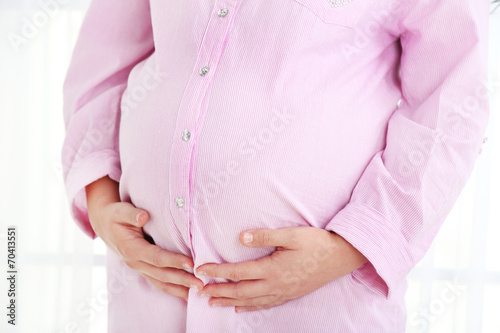 Wallpaper Mural Young pregnant woman on light background Torontodigital.ca