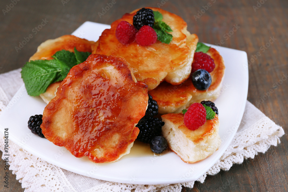 Tasty pancakes with fresh berries, honey and mint leaf Tasty pancakes with fresh berries, honey and mint leaf