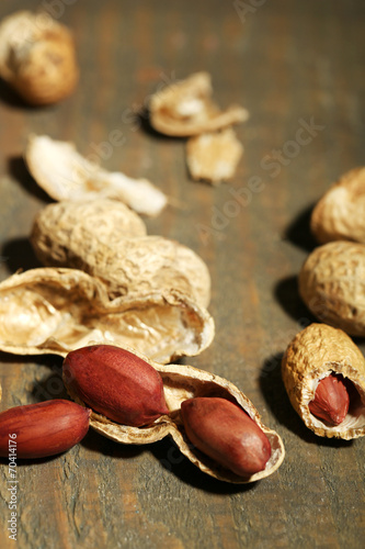 Peanuts in bowl on rustic wooden background