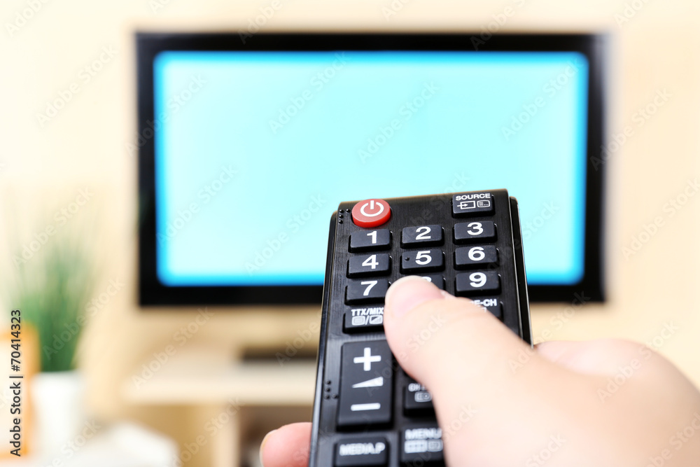Watching TV and using remote controller Watching TV and using remote controller