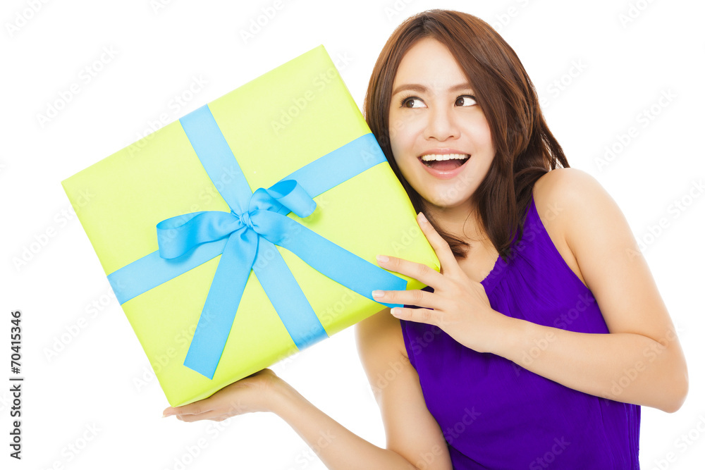 surprised young woman holding a gift box over white background surprised young woman holding a gift box over white background
