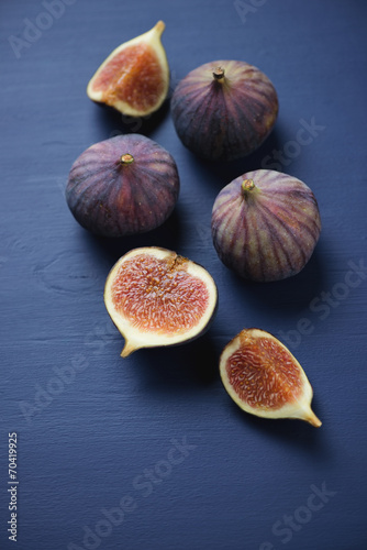 Close-up of whole and sliced fig fruits, vertical shot