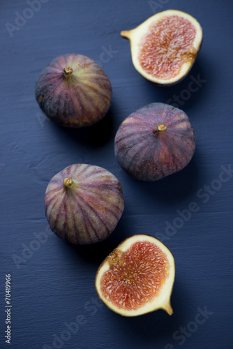 Ripe figs over dark blue wooden background, above view