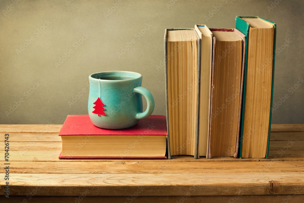 Vintage books and tea cup on wooden table StockFoto Adobe Stock