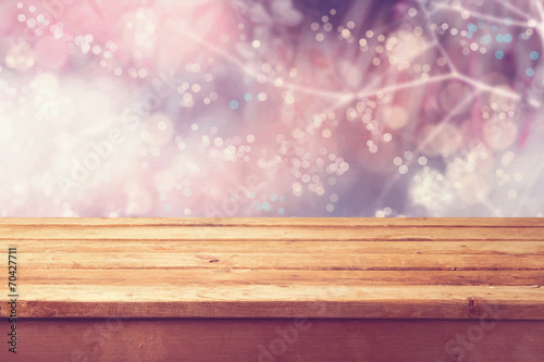 Beautiful winter bokeh background and wooden table © maglara
