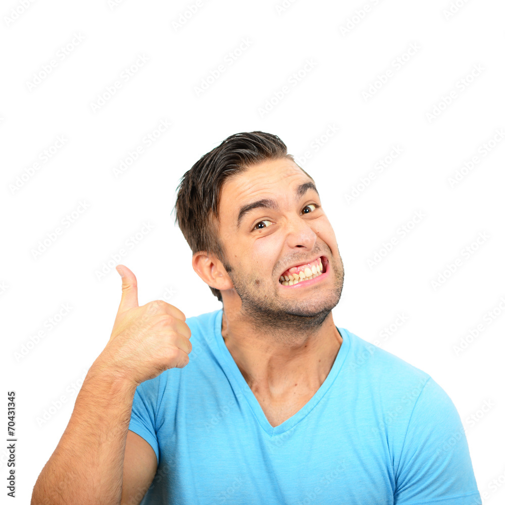 Fototapeta premium Portrait of with funny expression holding thumbs up against whit