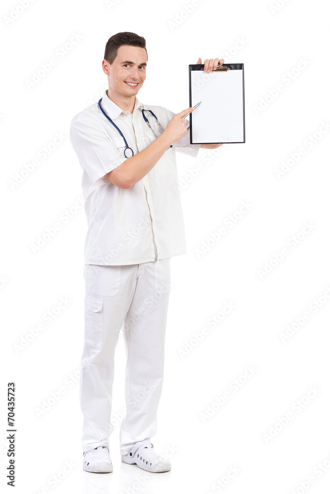 Young male doctor pointing at a clipboard Young male doctor pointing at a clipboard