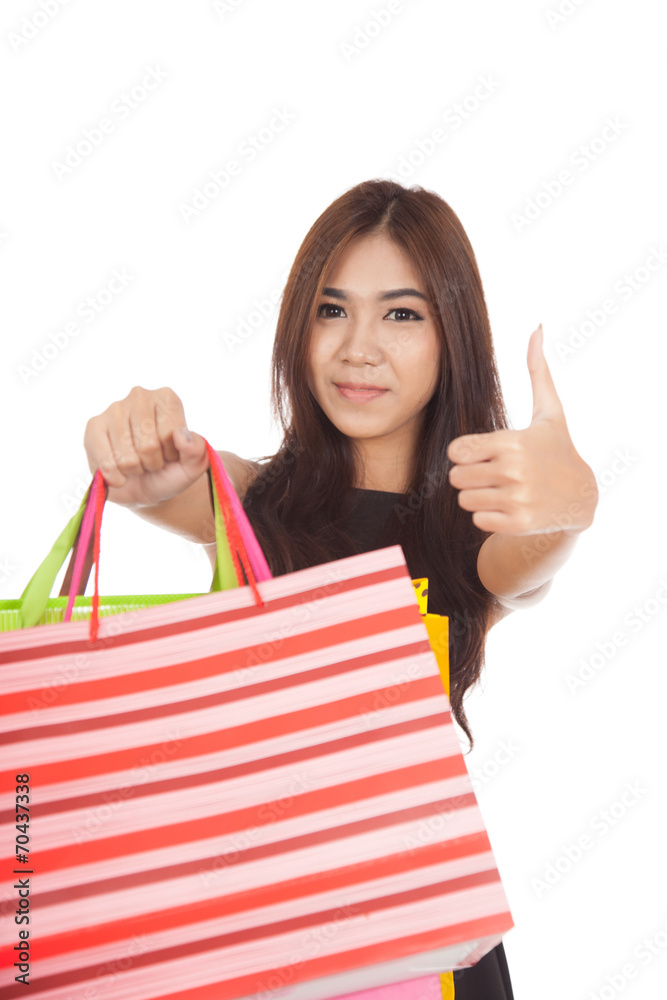 Asian woman show shopping bags and thumbs up Asian woman show shopping bags and thumbs up