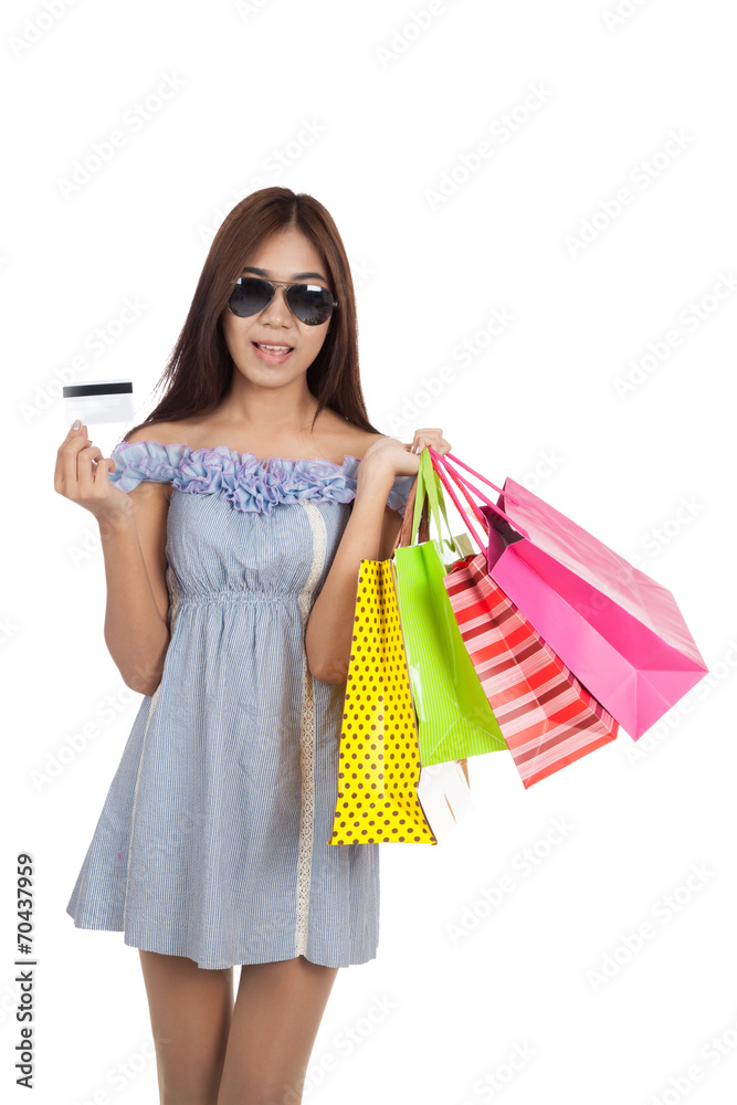 Asian woman wear sunglasses hold shopping bags show a credit car