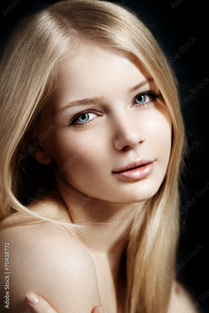 Woman face close up. A pretty young blond trendy. Girl with a be