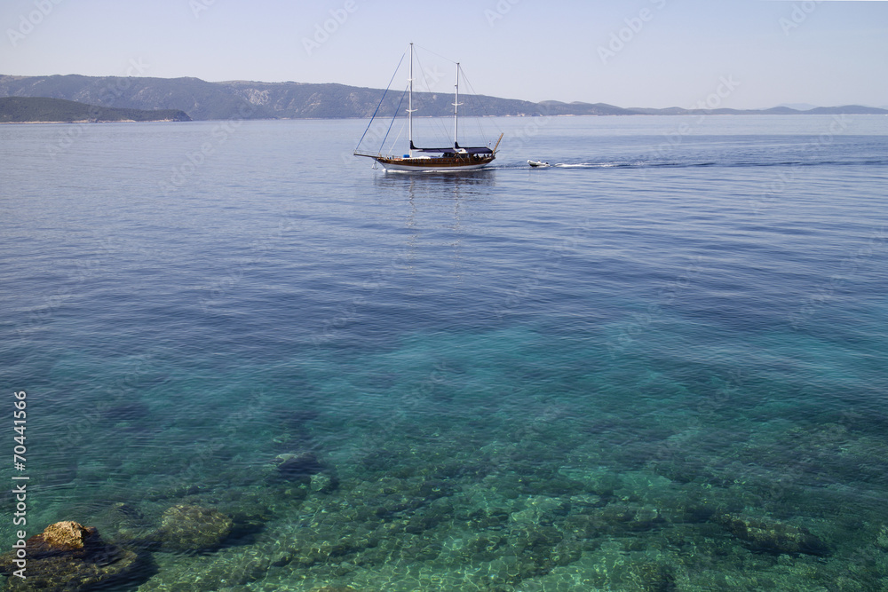 Fototapeta premium Wooden sailing boat with two masts near coastline of Brac island
