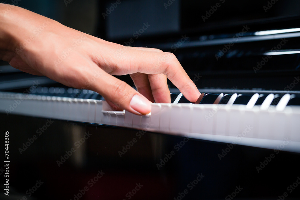 Fototapeta premium Asian male pianist playing piano in recording studio
