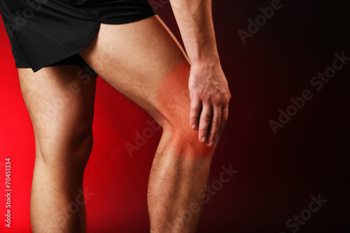 Pain concept.Young man with knee pain