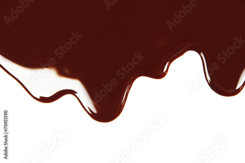 Melted chocolate dripping on white background