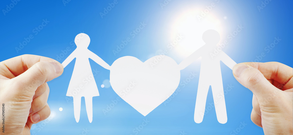 paper family with heart in hands paper family with heart in hands