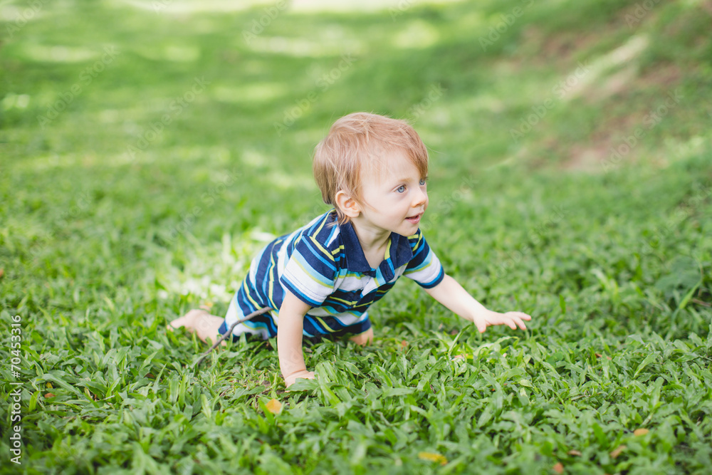 Cute little baby in summer park on the grass. Sweet baby outdoor Cute little baby in summer park on the grass. Sweet baby outdoor