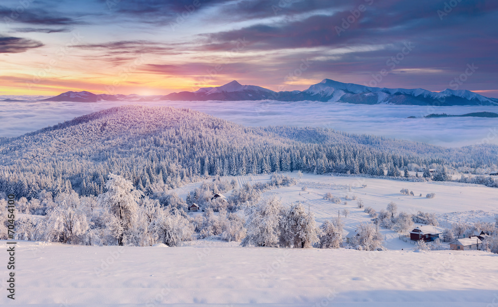 Panorama of the foggy winter sunrise in the mountain village