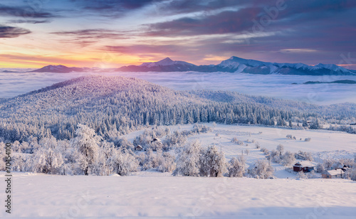 Panorama of the foggy winter sunrise in the mountain village