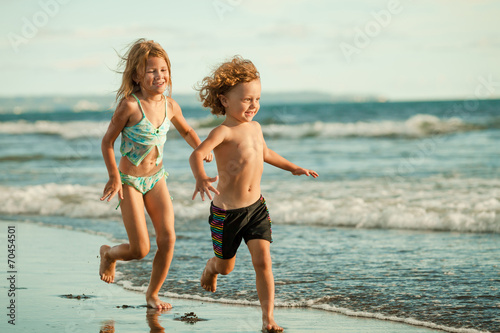 happy kids playing on beach in the day time