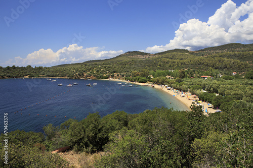 Public beach in the beautiful bay of the Aegean Sea. © Julia Mashkova