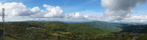 Panorama from a ridge on a cloudy summer day