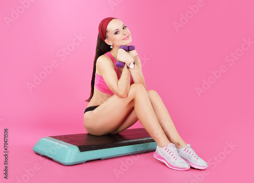Recreation. Slender Calm Woman with Dumbbells Relaxing