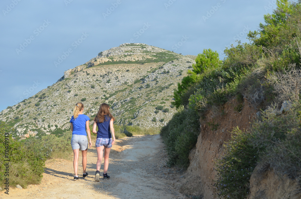 girls walking up mountain