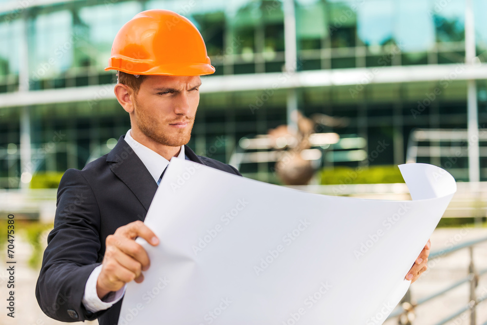 Architect examining blueprint. Architect examining blueprint.