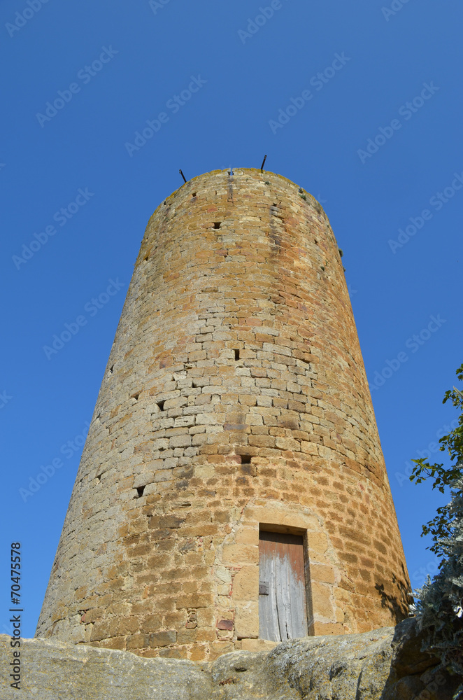 Tall ancient tower in medieval village of Pals