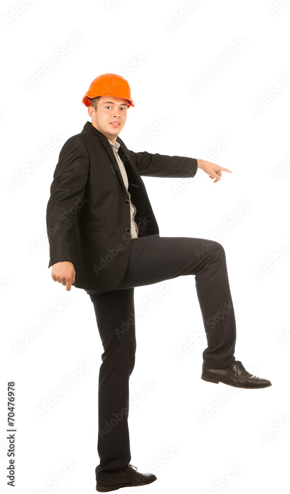 Young Male Engineer Lifting One Leg Posing