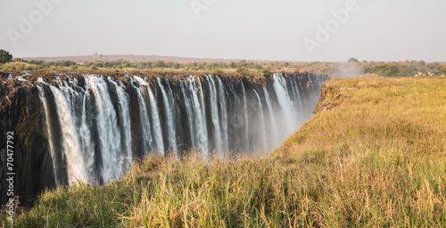 Panoramic view of Victoria Falls with toruists in Zimbabwe photo