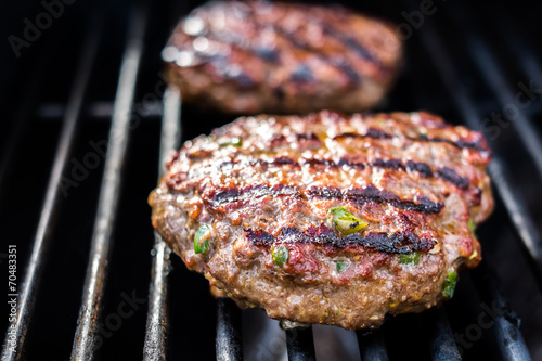 Hamburgers on the grill with stripes outdoors