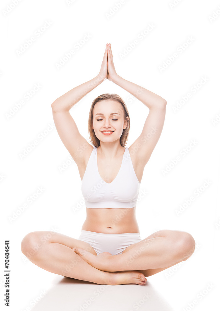 Young woman sitting in lotus position isolated Young woman sitting in lotus position isolated