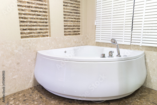 Jacuzzi in corner of bathroom