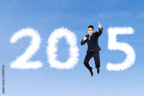 Businessman jumping to celebrate new year