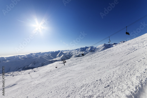 Off-piste slope and blue sky with sun © BSANI