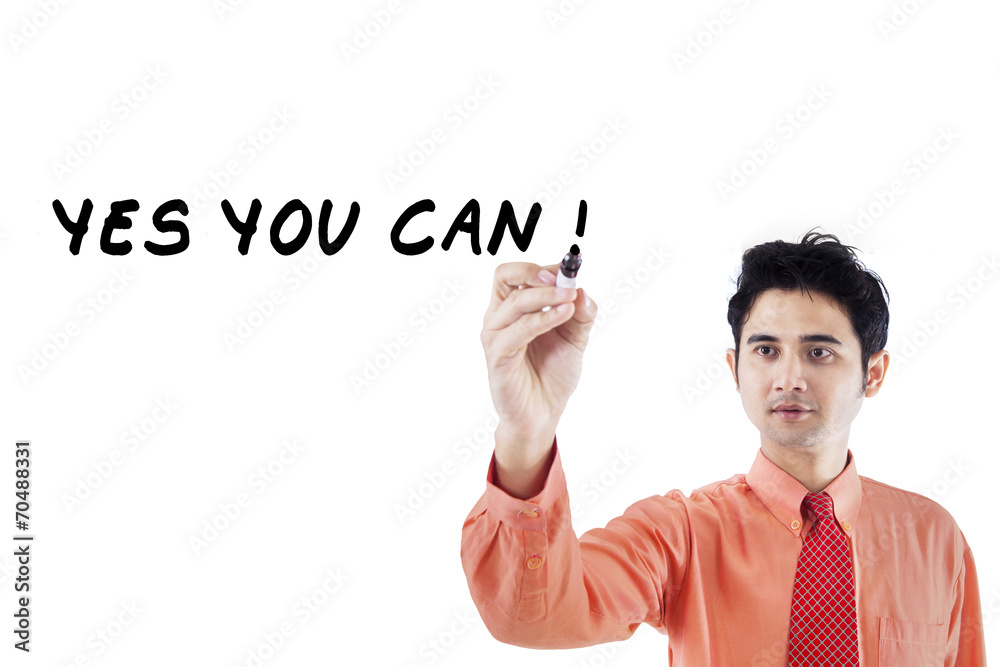Confident businessman writes on whiteboard 1 Confident businessman writes on whiteboard 1