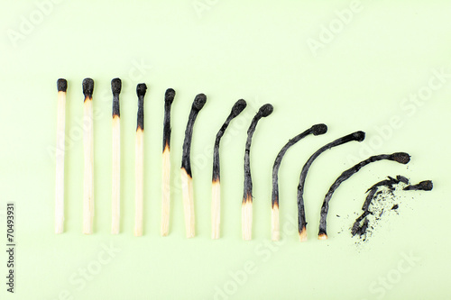 matches in different stages of burning  on color background