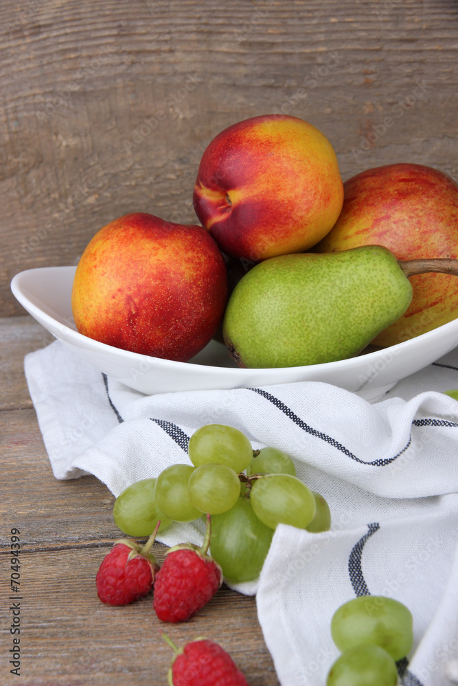 ripe fruits in bowl on wooden background ripe fruits in bowl on wooden background