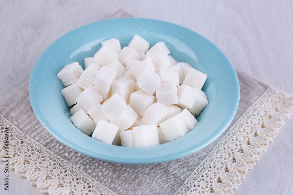 Refined sugar in color bowl on wooden background Refined sugar in color bowl on wooden background