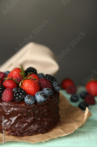 Tasty chocolate cake with different berries