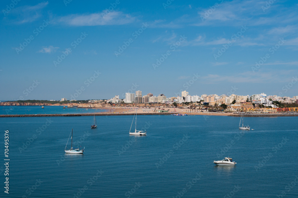 Portimao city view. Boats in the bay in sunny day