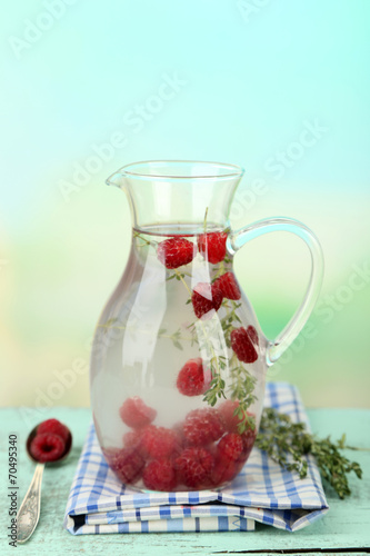 Tasty cool beverage with raspberries and thyme,