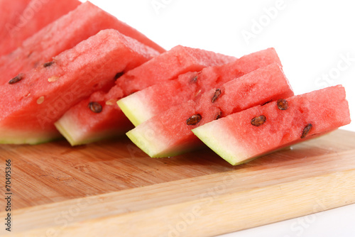 Slices of watermelon on cutting board isolated on white