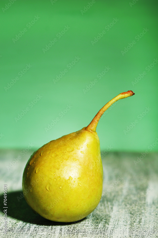 Ripe tasty pear, on wooden table