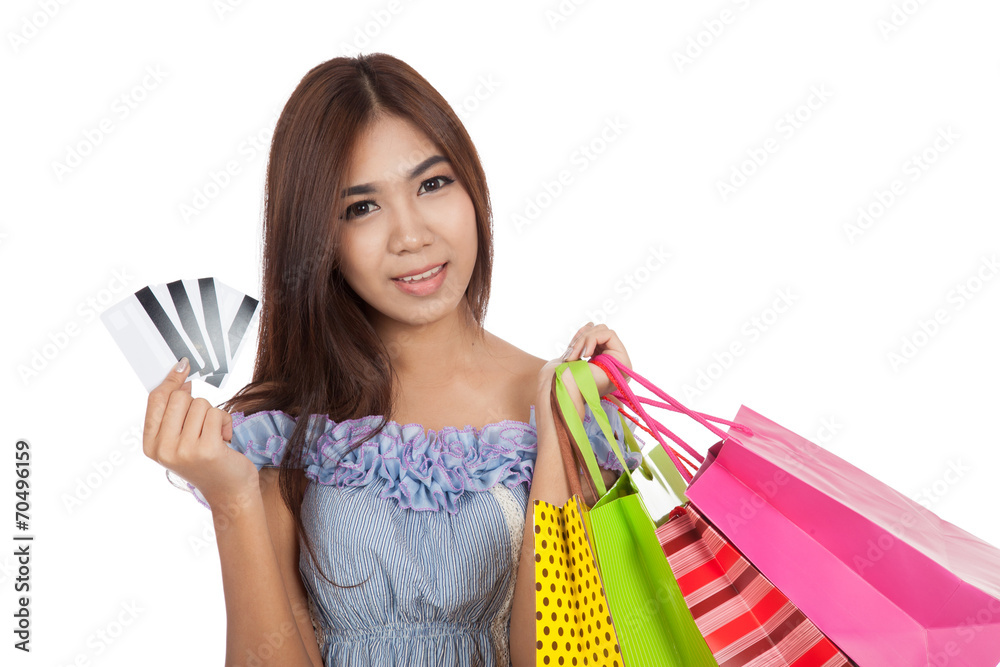Beautiful Asian woman hold shopping bags show credit cards Beautiful Asian woman hold shopping bags show credit cards