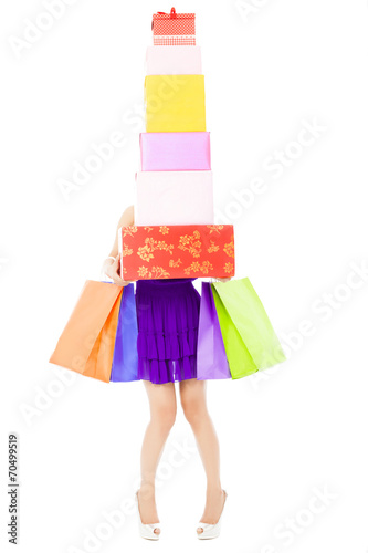 woman holding shopping bags and gift boxes over white background